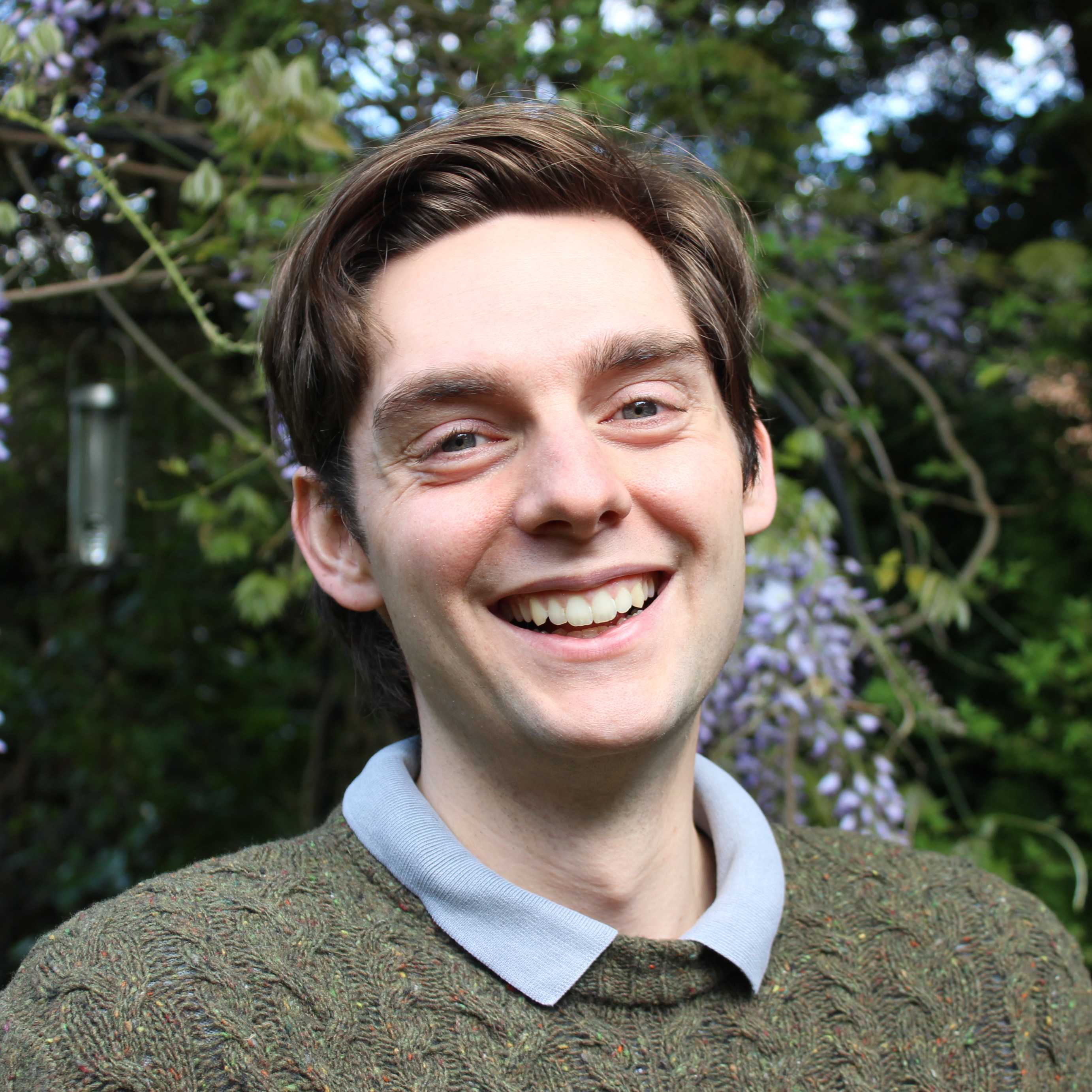 A photo of me, Sam, in my garden, smiling